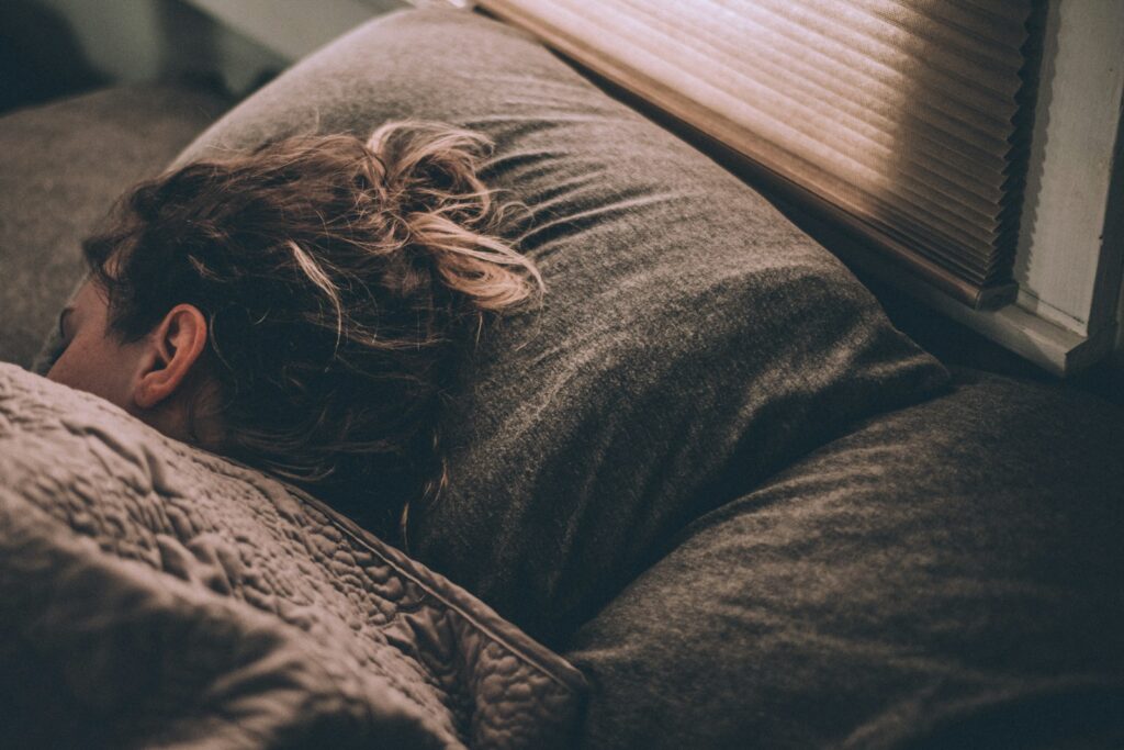 Woman sleeping under warm blankets