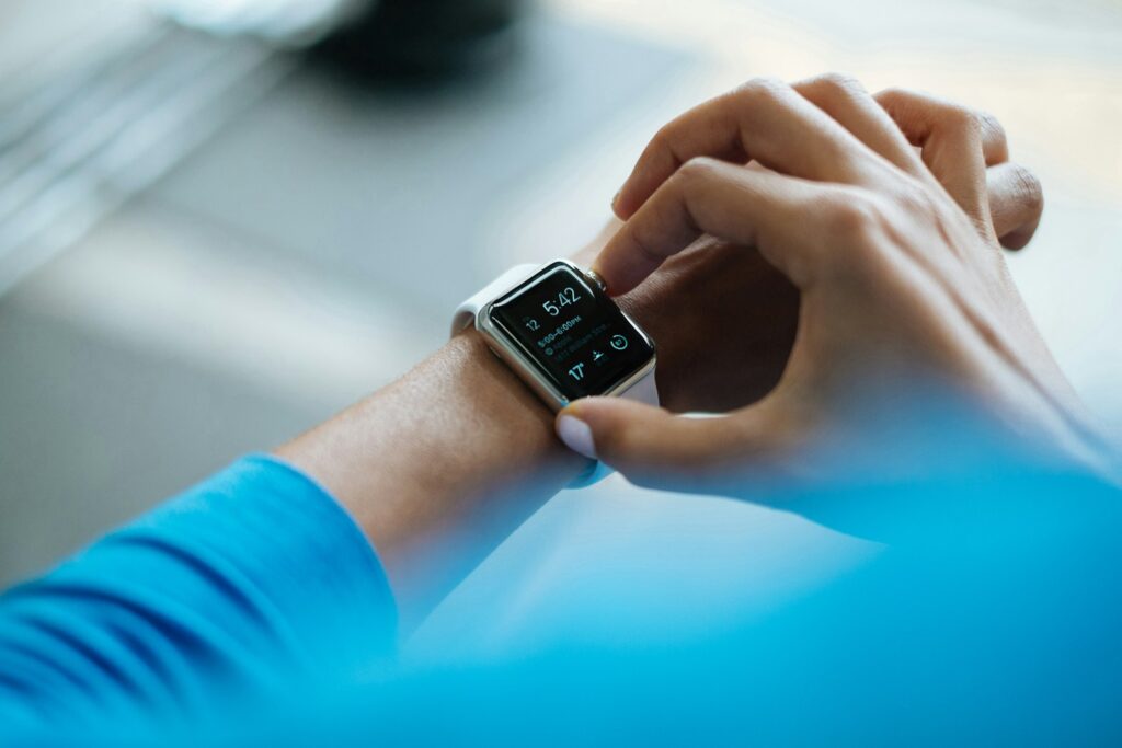 Person tapping a smartwatch on their wrist