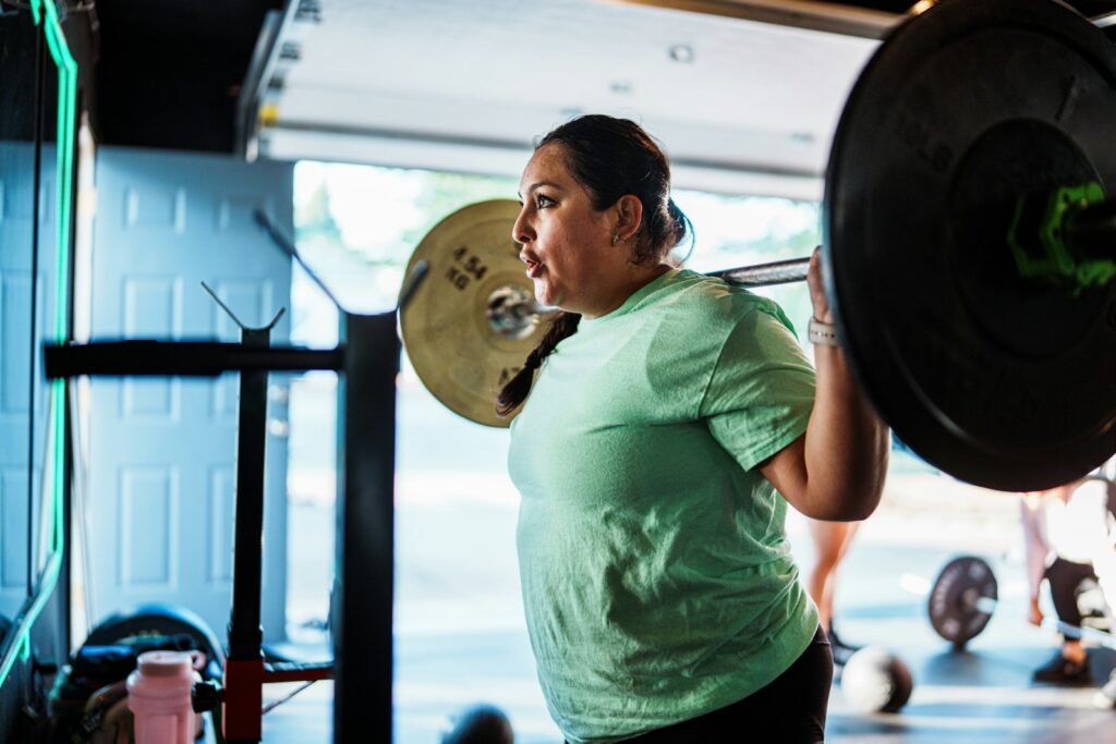Woman training with a barbell in the gym